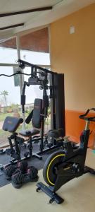 a gym with several exercise bikes and a tv at Villa Ban Tai Zero, Master Bedroom Bungalow in Nathon Bay