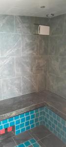 a bathroom with a swimming pool with blue tiles at Villa Ban Tai Zero, Master Bedroom Bungalow in Nathon Bay +12 photos