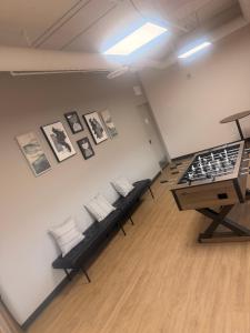 a room with chairs and a chess board on a wall at Urban Nest in Edmonton
