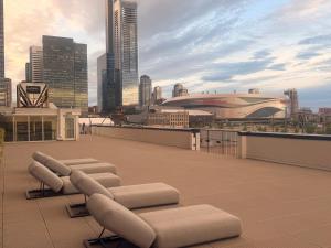 a row of lounge chairs on the roof of a building at Urban Nest in Edmonton