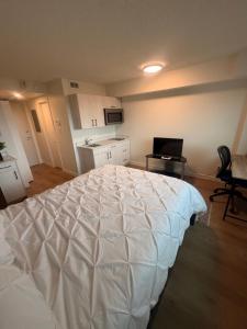 a bedroom with a large white bed in a room at Urban Nest in Edmonton +22 photos