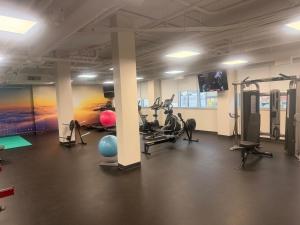 a gym with treadmills and exercise bikes in a room at Urban Nest in Edmonton