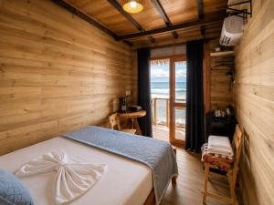 a bedroom with a bed and a view of the ocean at Palmarío Beach House in Guachaca