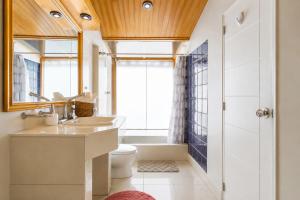 a bathroom with a sink and a toilet and a window at Sumaq Sisa Home & Loft in Cusco +27 photos