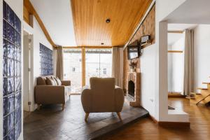 a living room with a couch and a fireplace at Sumaq Sisa Home & Loft in Cusco