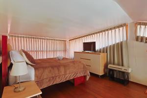 a bedroom with a bed and a tv in it at Sumaq Sisa Home & Loft in Cusco