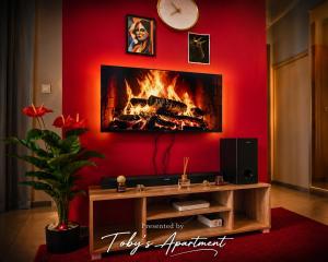a living room with a fire in the wall at Toby's Apartment in Mbabane