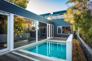 an external view of a house with a swimming pool at East Lane in Tathra