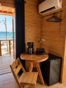 a kitchen with a table with a coffee maker on it at Palmarío Beach House in Guachaca