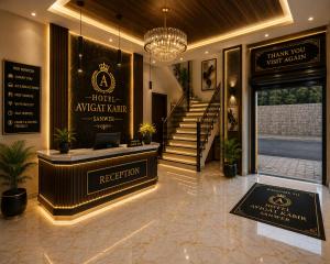 a hotel lobby with a reception desk and stairs at Hotel avigat kabir sanwer in Indore