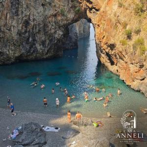a group of people in the water at a beach at Casa Anneli - Scalea Park 2000 in Scalea +4 photos
