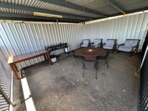 an empty room with a table and chairs in it at Warren Motor Inn in Warren
