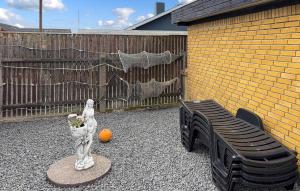 a patio with two chairs and a statue of a cat at Awesome Home In Thyborøn With Wifi in Thyborøn