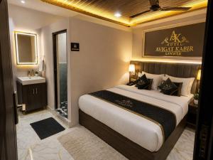 a bedroom with a large bed and a bathroom at Hotel avigat kabir sanwer in Indore