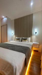 a bedroom with a large bed with lights on it at Marvarid INN in Samarkand