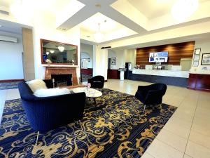 a living room with a couch and chairs and a fireplace at Quality Hotel Mildura Grand in Mildura