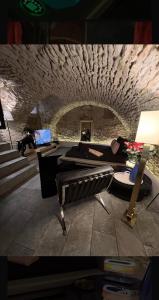 a picture of a room with a stone wall at Maison Stanislas Spa Suites in Nancy