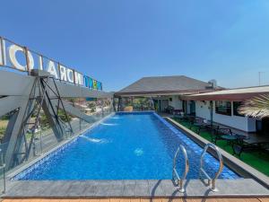 a swimming pool in front of a building at Front One Resort Indraloka Temanggung in Temanggung