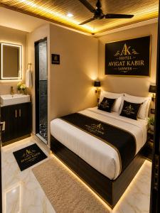 a bedroom with a large bed and a bathroom at Hotel avigat kabir sanwer in Indore +15 photos