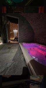 a room with a hot tub with purple lights at Maison Stanislas Spa Suites in Nancy
