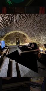 a stone room with a bed and a fireplace at Maison Stanislas Spa Suites in Nancy