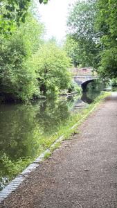 a bridge over a river next to a road at Dream easy in Birmingham
