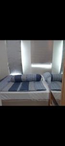 a close up of a bed on a boat at osaka riverview apartment in Rawalumpang