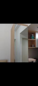 a reflection of a room with a mirror and a cabinet at osaka riverview apartment in Rawalumpang