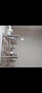 a shelf in a bathroom with a bottle of soap at osaka riverview apartment in Rawalumpang