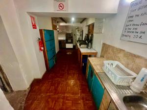 a kitchen with a counter and a sink in it at Intihuatana Hostel in Pisac