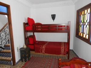 a bedroom with a bunk bed in a room at Petit Bijou de Tanger in Tangier