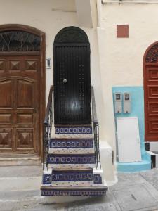 a staircase in front of a building with a door at Petit Bijou de Tanger in Tangier