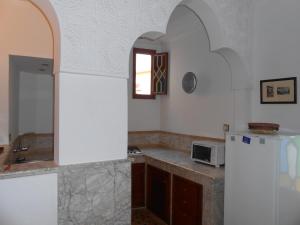 a kitchen with a sink and a refrigerator at Petit Bijou de Tanger in Tangier