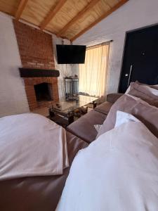 a living room with a couch and a flat screen tv at Descanso Cuchilla Alta in Cuchilla Alta +69 photos