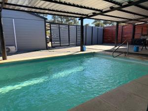 an empty swimming pool with an open roof at Descanso Cuchilla Alta in Cuchilla Alta