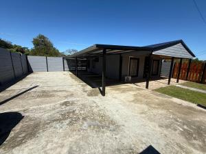 a garage with a black roof on top of it at Descanso Cuchilla Alta in Cuchilla Alta