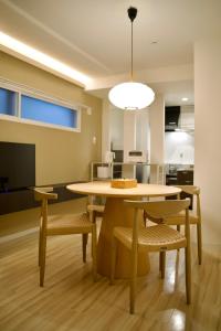 a dining room table with chairs and a light fixture at Grand Success Kotoni ll in Sapporo