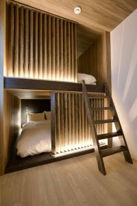 a bunk bed with a staircase in a bedroom at Grand Success Kotoni ll in Sapporo