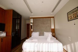 a bedroom with a large bed with white sheets at Irit pyramids inn in Cairo +32 photos