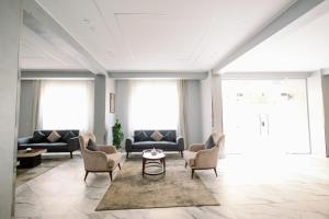 a living room with couches and chairs and a table at Irit pyramids inn in Cairo