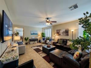a living room with a couch and a ceiling fan at Amazing Grace Vacation Home in Las Vegas