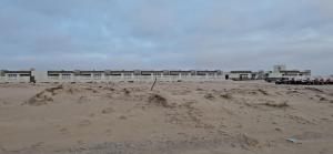 a pile of sand on a beach with a building at AlSeef 161 in Al Sharqiyah +3 photos