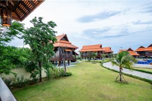 a view of a resort with trees and buildings at Heritage Village Resort in Kampot +51 photos