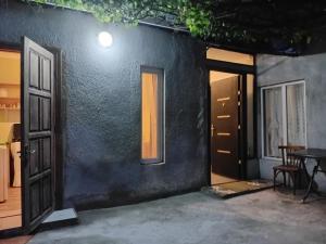 an open door of a house with a table and a window at borjomi downtown in Borjomi