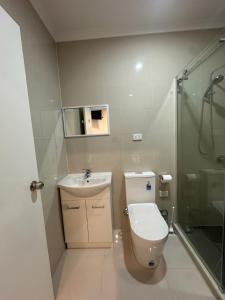 a bathroom with a toilet and a sink and a shower at Guest Room in Joan in St Albans