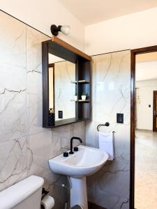 a bathroom with a sink and a mirror at Apart Mirador del Valle in Cachí