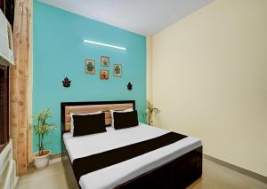 a bedroom with a bed with a blue wall at Shivik stays in Gurgaon