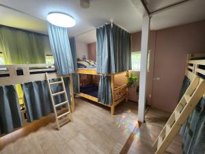 a room with two bunk beds in it at Peace House Isonoura in Wakayama