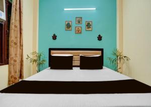 a bedroom with a large bed with a blue wall at Shivik stays in Gurgaon