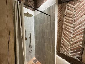 a bathroom with a shower with a shower curtain at La landaise in Commensacq +39 photos